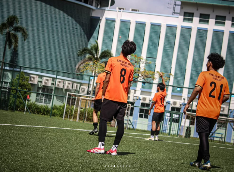 CCKSS football team in action during a competitive school football match.